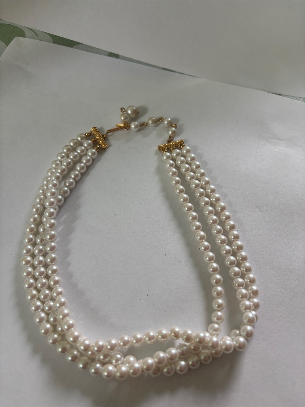 Three-Strand White Pearl Necklace with Gold Accents